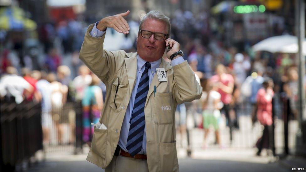 A trader outside the New York Stock Exchange (24 Aug 2015)