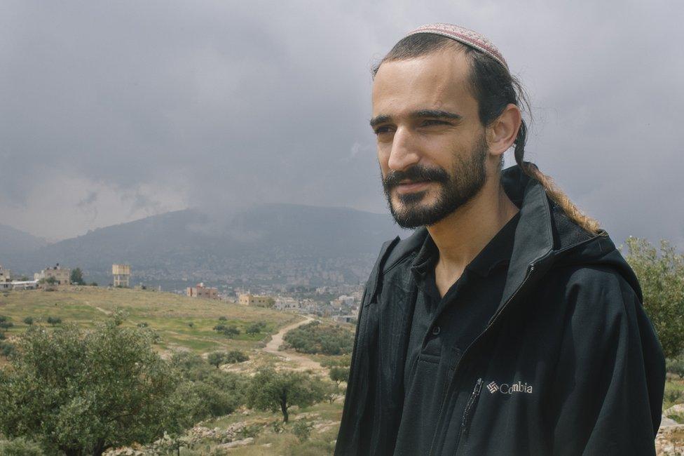 Michael stands for a portrait in Elon More Settlement, West Bank