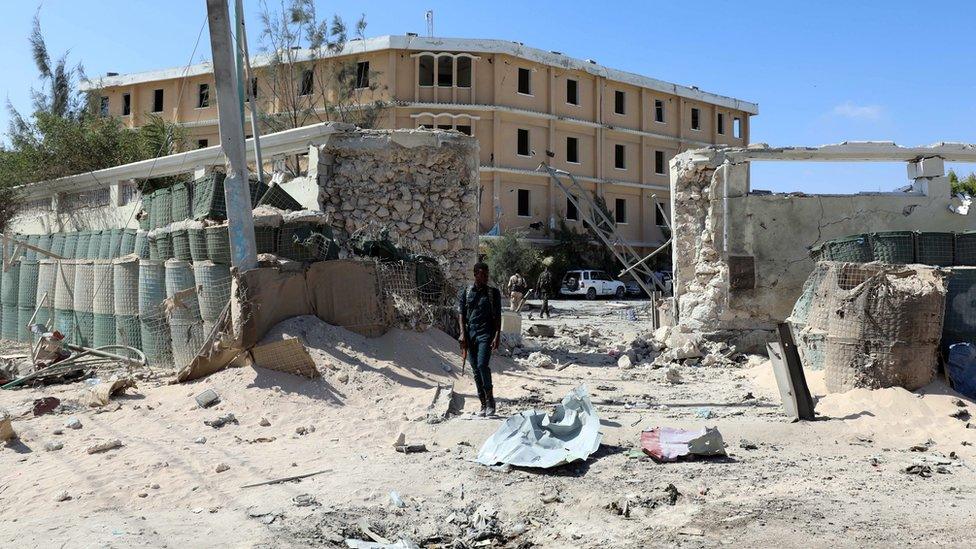 Policemen security forces secure the scene where al-Shabab militia stormed a government building in Mogadishu