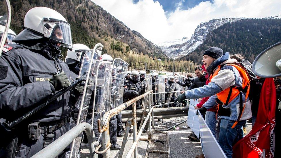 Riot police face protesters during a rally against the Austrian government's planned re-introduction of border controls at the Brenner Pass, Austria, 24 April 2016