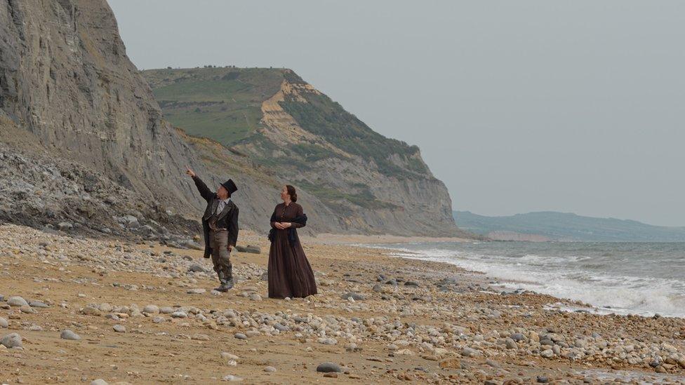 Characters from the film standing on the beach