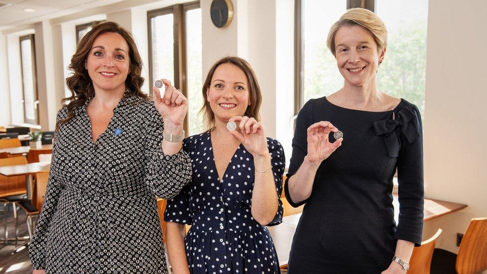 (left to right) Ellie Orton, CEO of NHS Charities Together, Alice Lediard Designer of the NHS 50p and Amanda Pritchard, CEO of NHS England holding the NHS 75th Anniversary 50p