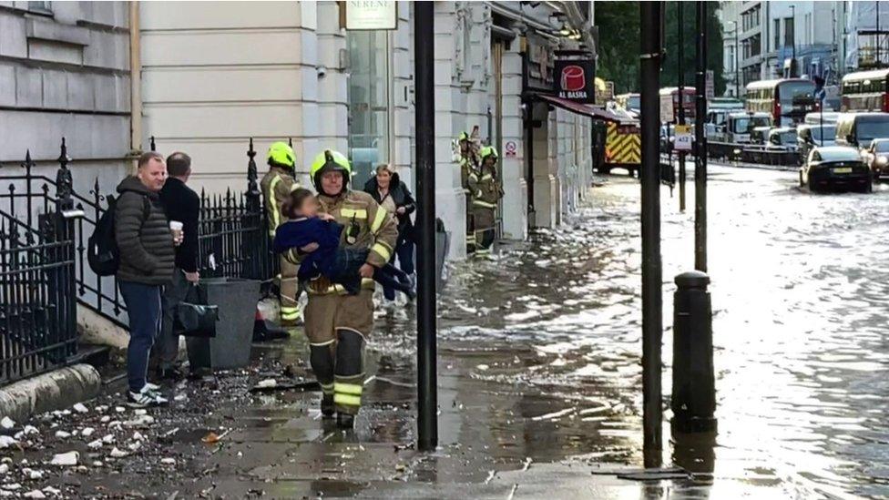 Firefighter carries girl