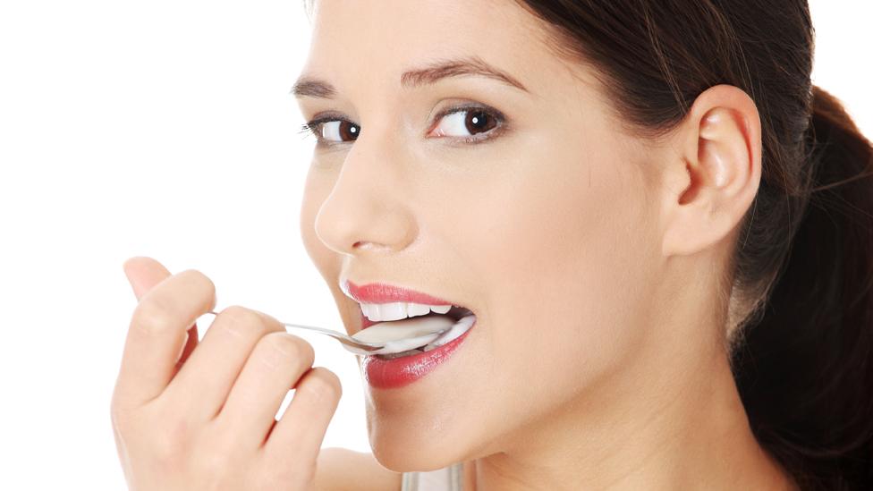 Generic picture of woman eating yogurt