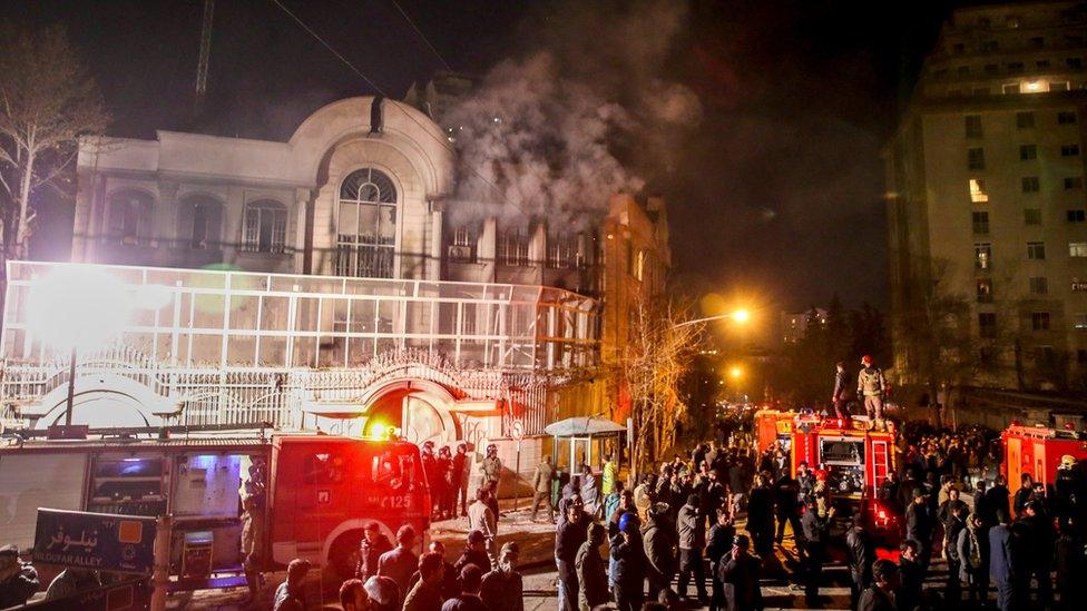 Smoke rises as Iranian protesters set fire to the Saudi embassy in Tehran (3 January 2016)