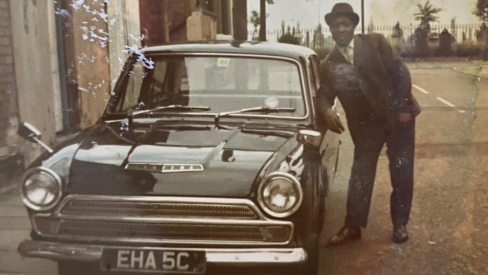 Man with car he bought through savings scheme