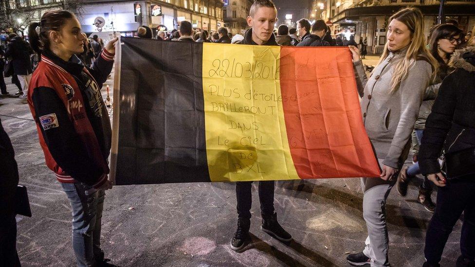 People gather and light candles at the Place de la Bourse during a vigil to pay tribute to the victims of the attacks in Brussels, Belgium. 22 March 2016