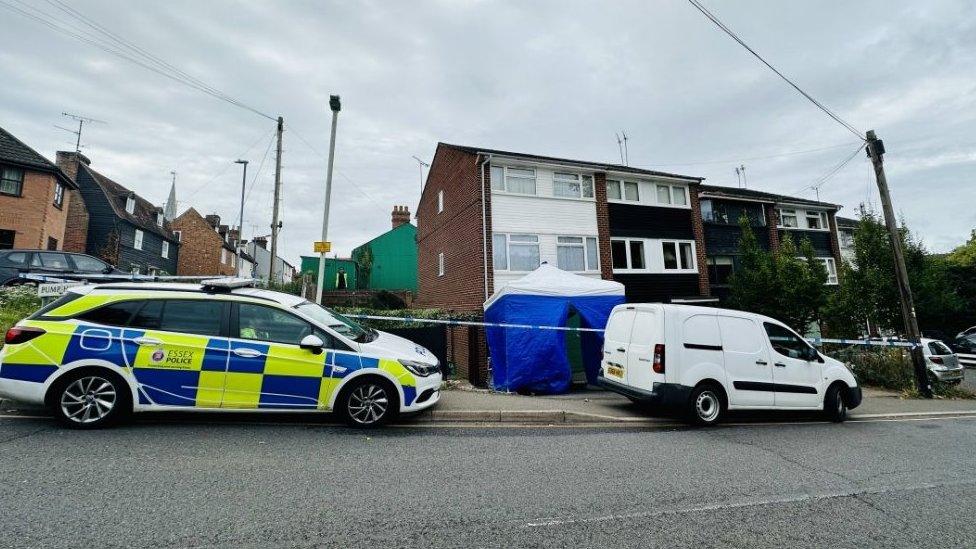 Tent, cordon and police vehicles outside house in Pump Hill