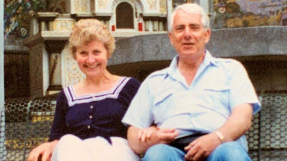 Stuart's mum and dad sat on a bench together