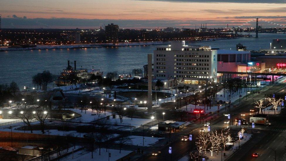 The Detroit River flows between the downtown area and Windsor, Canada (background), March 2, 2016 in Detroit, Michigan.