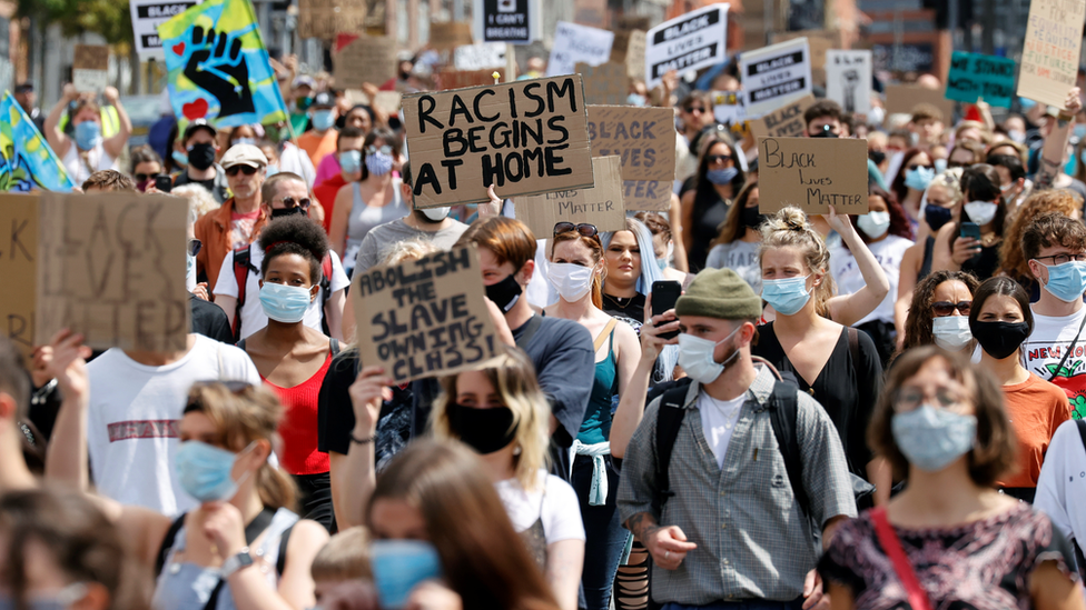 Demonstrators wade through Liverpool streets