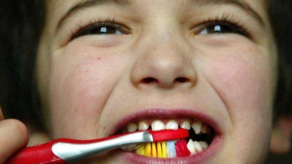 Child brushing teeth