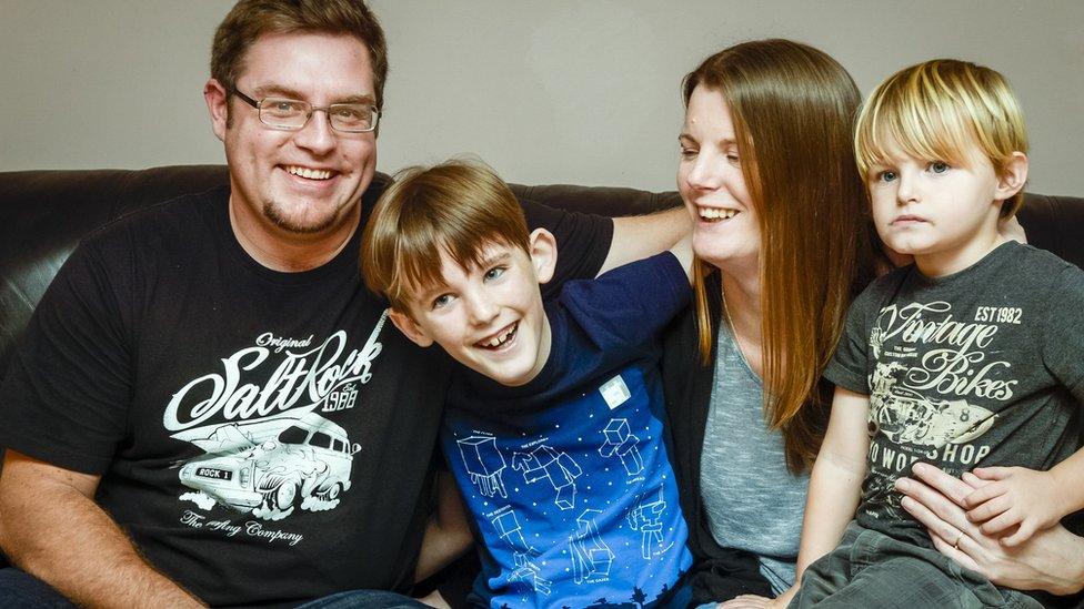 Nathan (centre) and his family