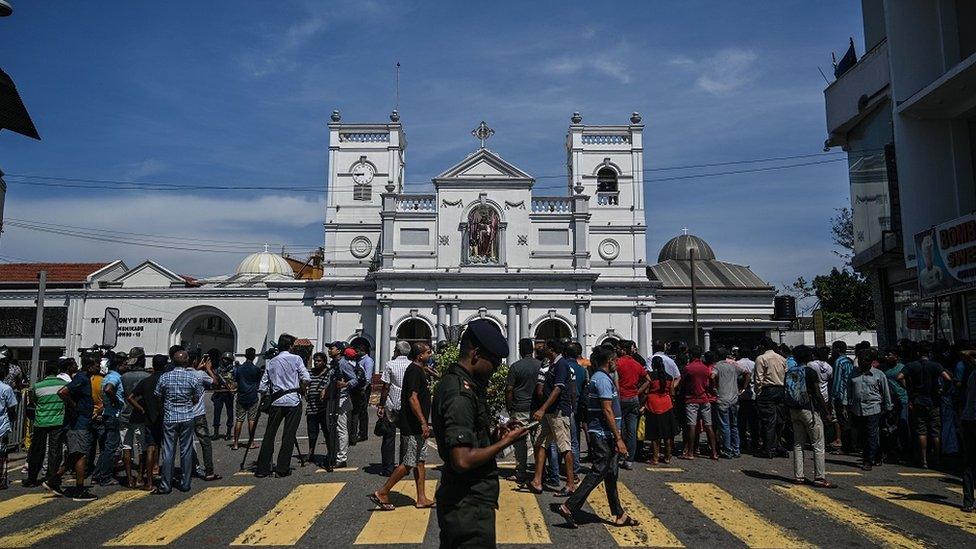 Local residents gather outside the St. Anthony"s Shrine in Colombo on April 22, 2019, a day after the building was hit as part of a series of bomb blasts targeting churches and luxury hotels in Sri Lanka.