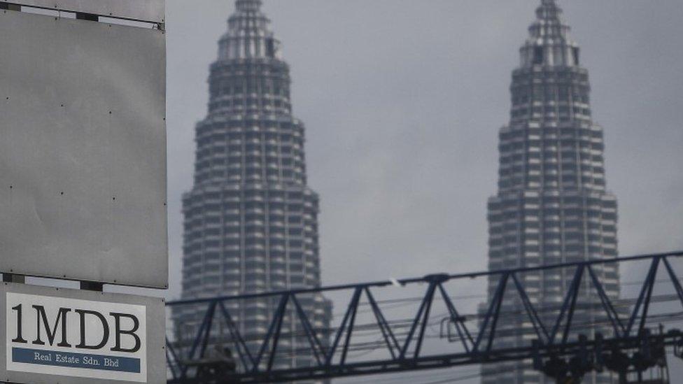 1MDB logo is set against the Petronas Twin Towers