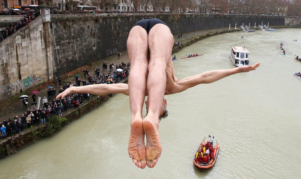 Marco Fois of Italy dives into the Tiber River from the Cavour bridge in Rome, Italy, 1 January 2018