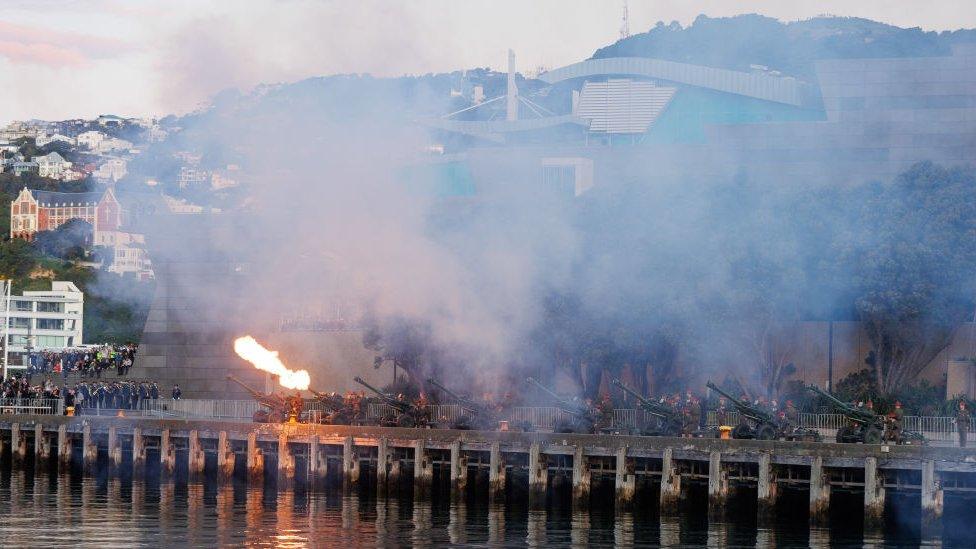 Large cannons go off in Wellington, New Zealand, whilst crowds watch by.