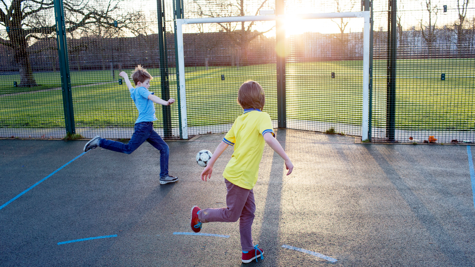 Two children playing in the sunshine