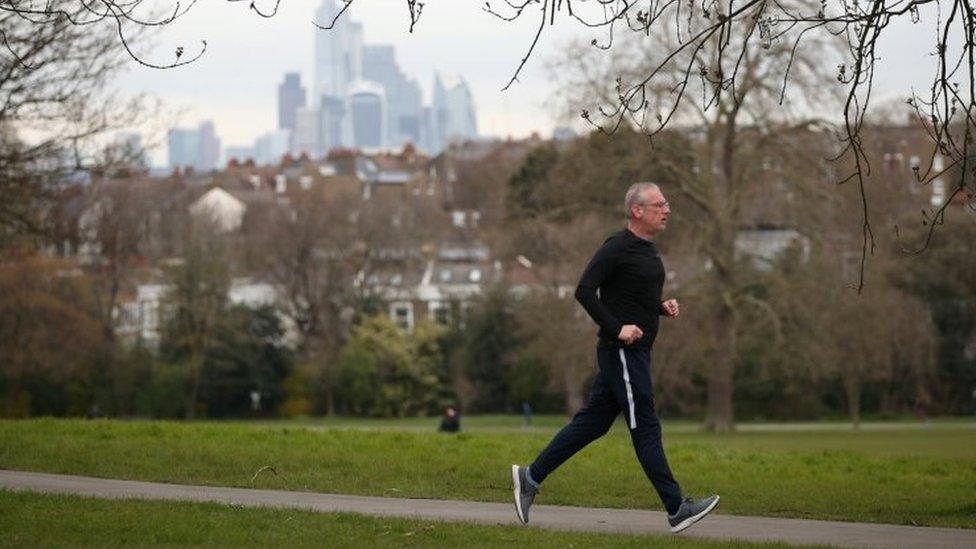 A man jogs in London's Brockwell Park on Friday 3 April