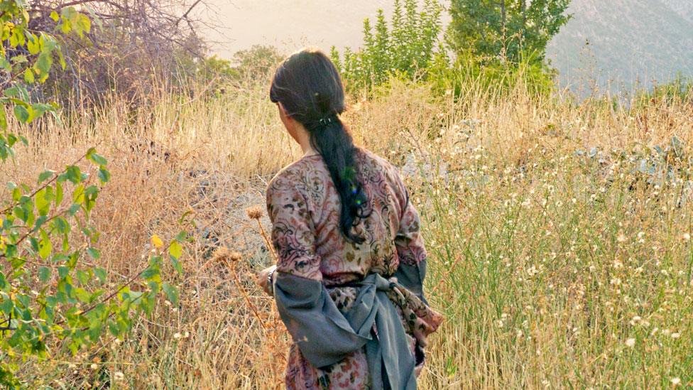 Silav in the fields around the village where she grew up - since destroyed by Iraqi troops