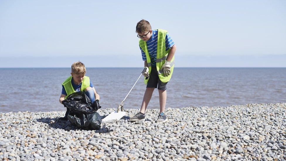 Kids litter picking at beach