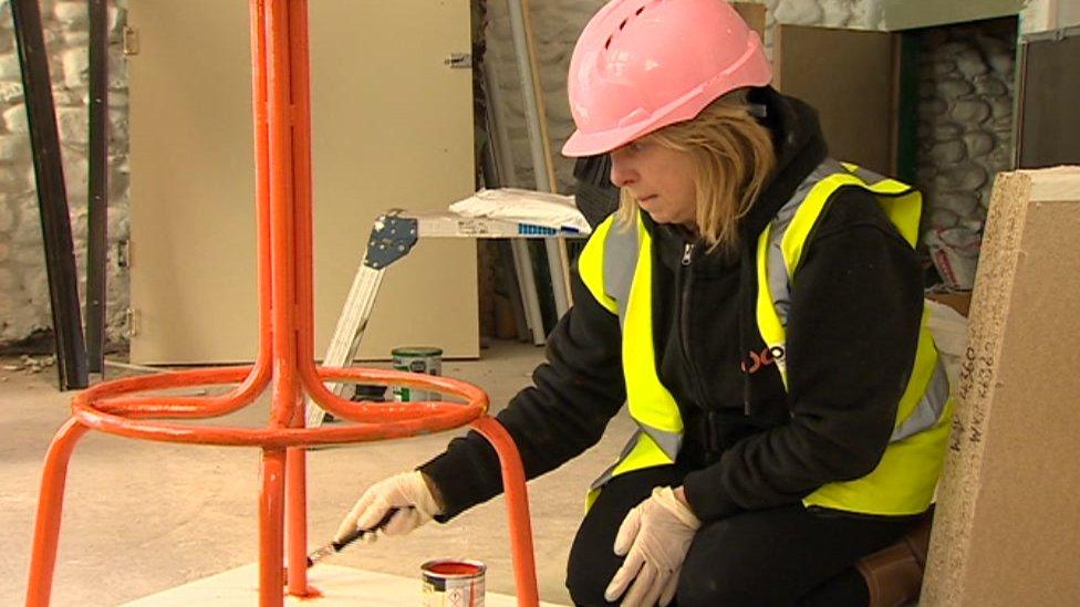 Mr Smith's wife Tanya paints a chair