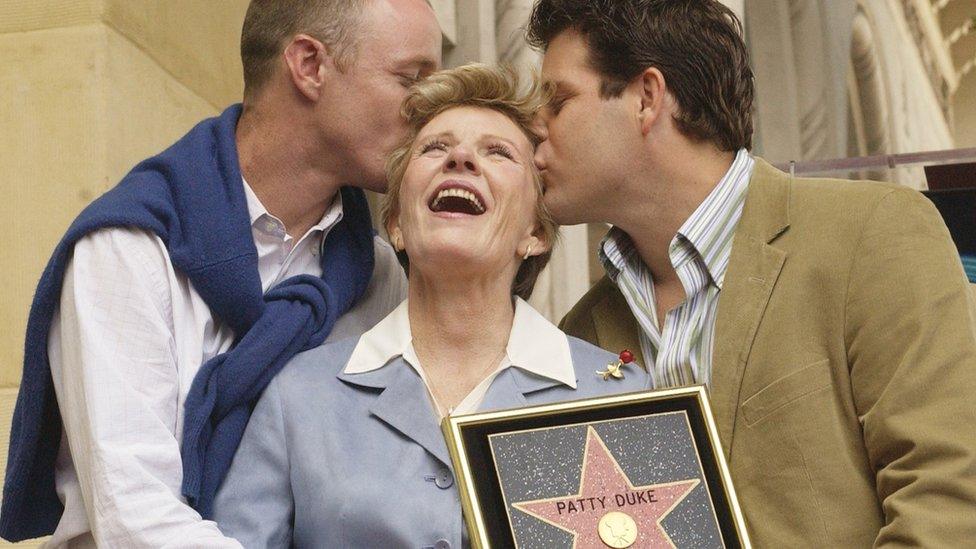 Patty Duke receives kiss from sons, Mackenzie (L) and Sean Astin following unveiling ceremony honouring Duke with a star on the Hollywood Walk of Fame in Los Angeles, California. 2004