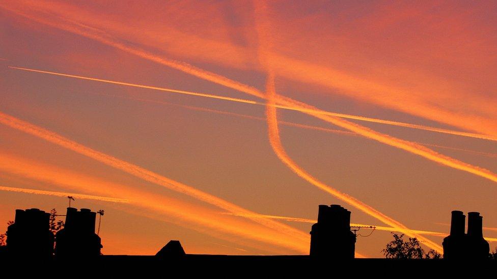 Vapour trails from aircraft landing and taking off from Heathrow and London City airports