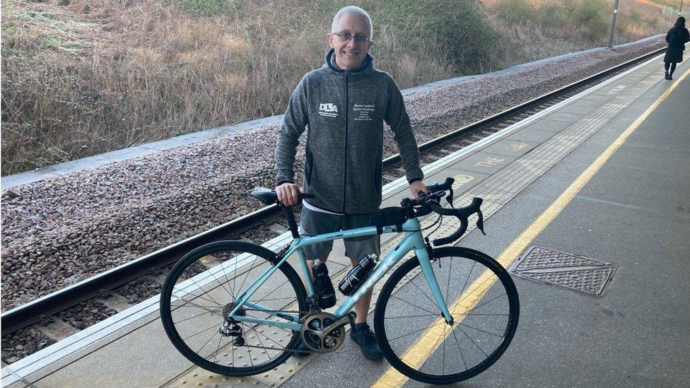 Mark Crowther and his blue-framed bike at Milton Keynes railway station