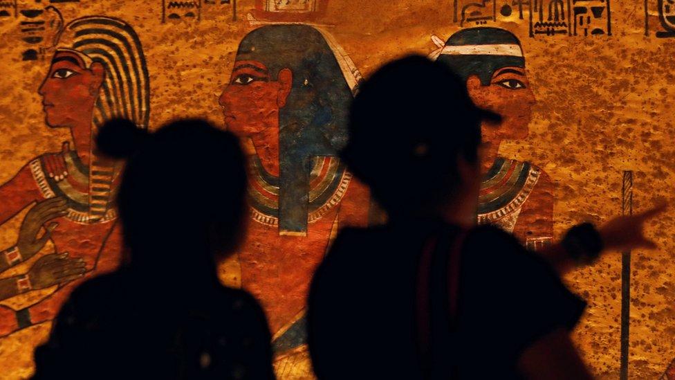 Visitors look at paintings inside the newly restored tomb of King Tutankhamun in the Valley of the Kings, Egypt (31 January 2019)