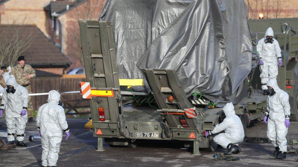 Military personnel remove an ambulance from the scene