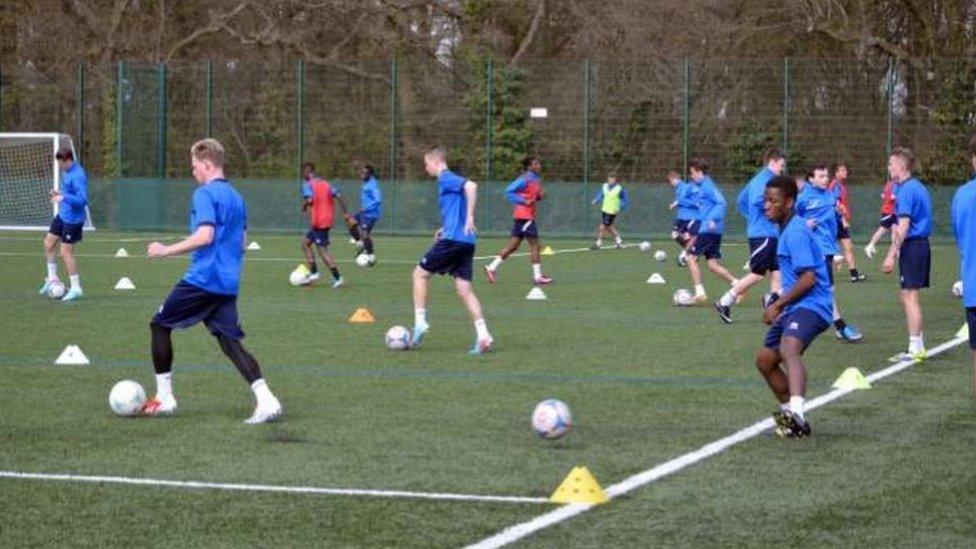 Young football players train