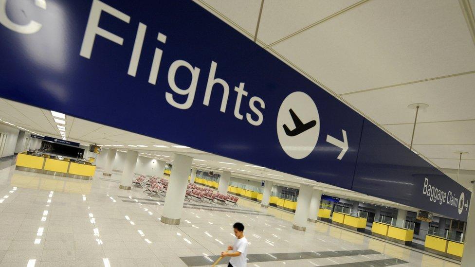 Worker cleans the arrival area of Ninoy Aquino International Airport