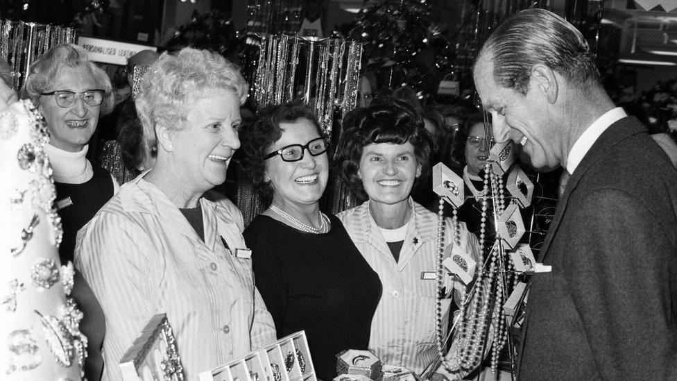 Prince Philip, Duke of Edinburgh, pictured during a visit to the West Midlands. The jewellery counter catches his eye on his way through Lewis's store, he stops to have a chat to the sales staff. Birmingham, 12th November 1970.