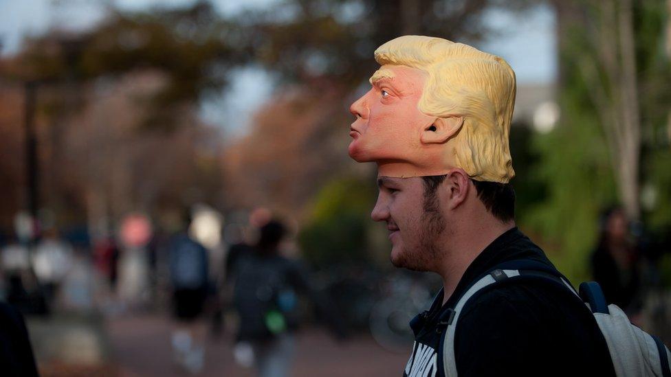 A freshman, stands outside the polling location on Penn State University's campus hoping to convince fellow students to vote for Donald Trump