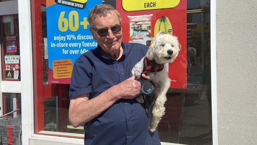 Mike Staines with his dog outside a shop in Swaffham