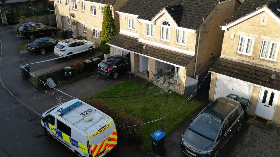 A drone picture of the damaged house and car