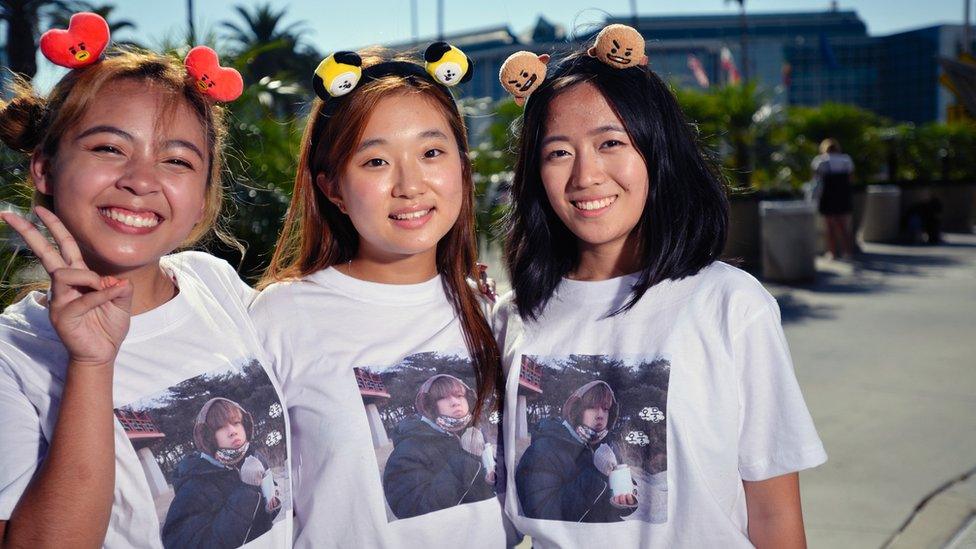 BTS fans excitedly wait ahead of a concert.