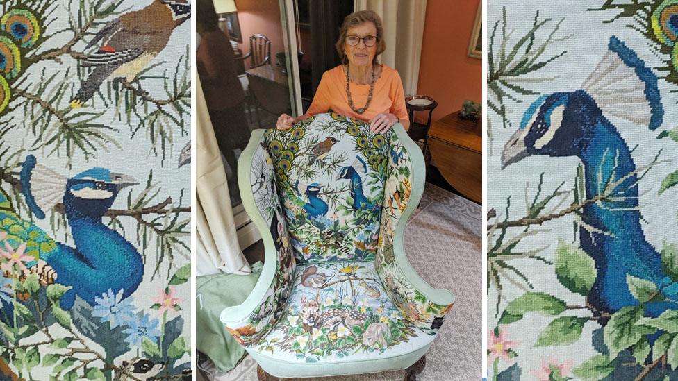 Nanny Pat with the chair that has propelled her to fame - it is an armchair with wildlife including peacocks and other birds and animals depicted on it.