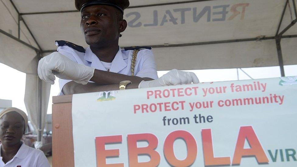 A health official waits to screen for the Ebola virus Muslim faithfuls on pilgrimage to Mecca on September 19, 2014 at the Murtala Mohammed International Airport in Lagos.