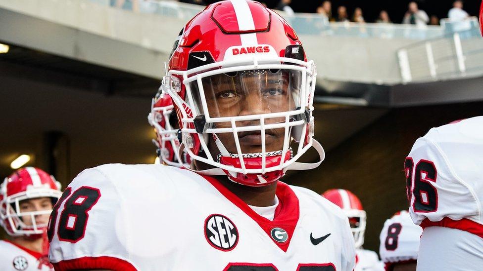 Football player looks over the field.