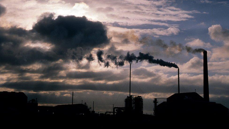 Industrial chimneys billowing smoke