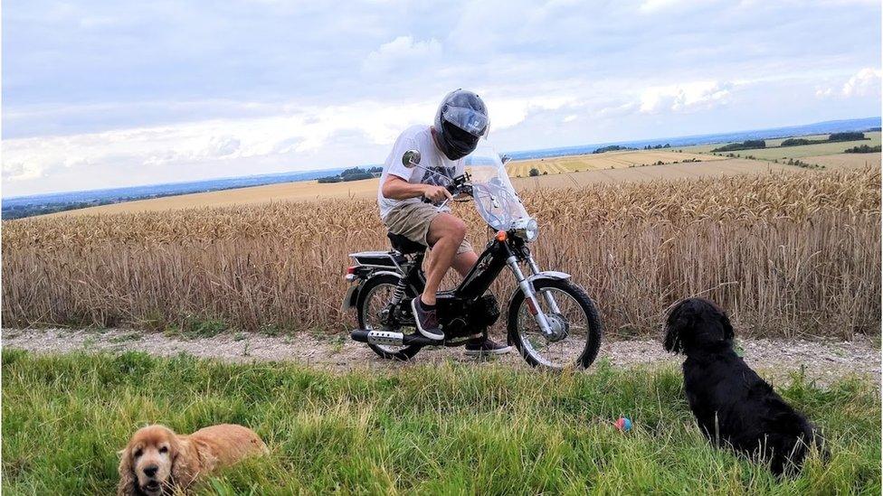 Paul Taylor on his moped accompanied by his two dogs