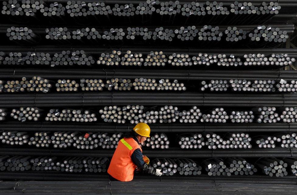 A labourer marks steel bars at a steel and iron factory in Huai"an, Jiangsu province, in this 18 February 2008 file photo.