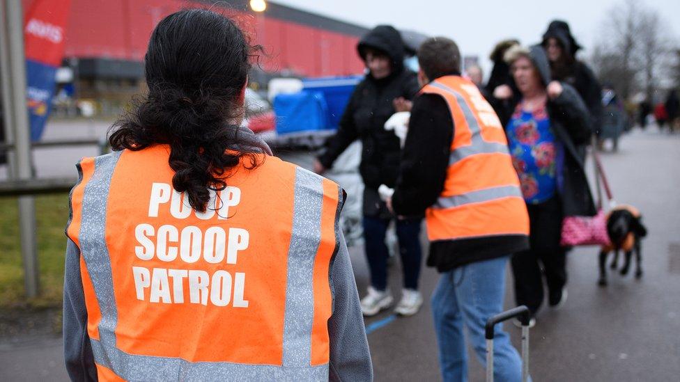 Woman in poop scoop patrol jacket