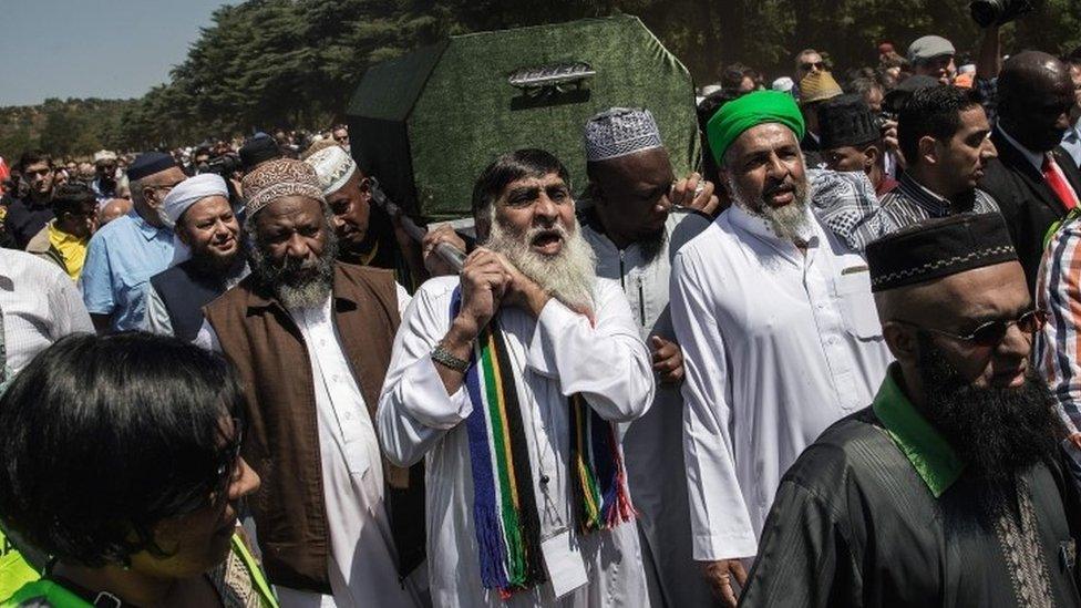 Coffin bearers carry the casket of late South African anti-apartheid activist Ahmed Kathrada during the funeral ceremony at the Westpark Cemetery in Johannesburg,