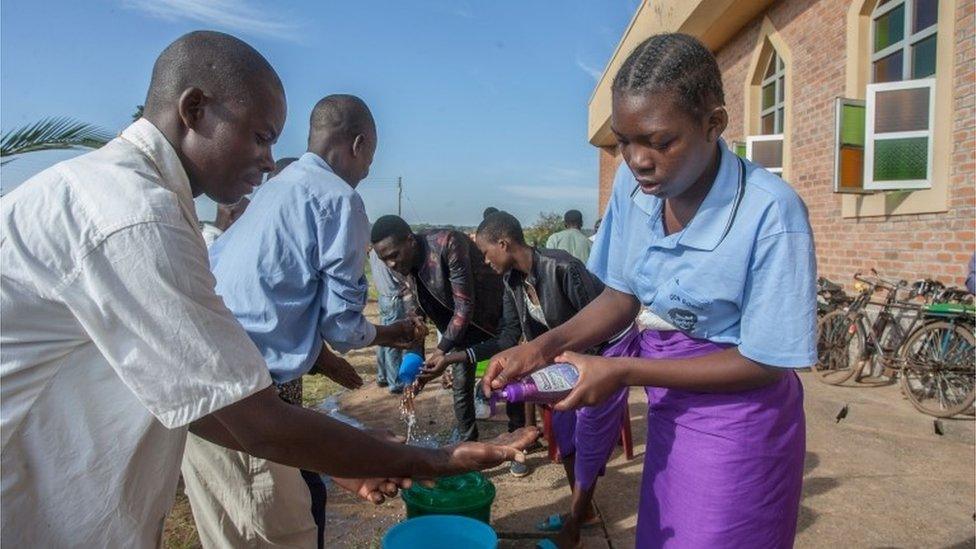 Parishioners wash hands as a preventive measure against the spread of Covid-19 on the last day of full gatherings as a parish at the Saint Don Bosco Catholic Parish in Lilongwe on March 22, 2020