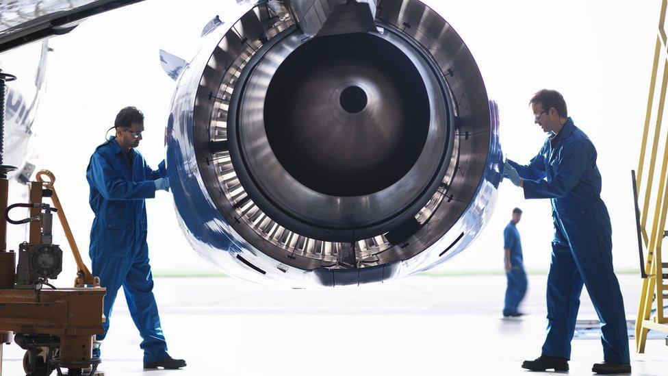 Engineers working on an engine