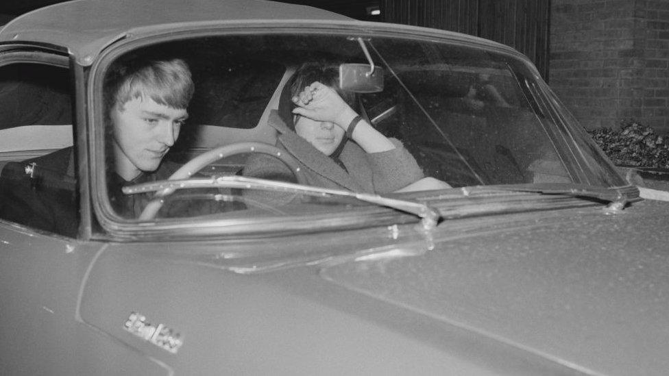 Tara Browne driving a car in the 1960s