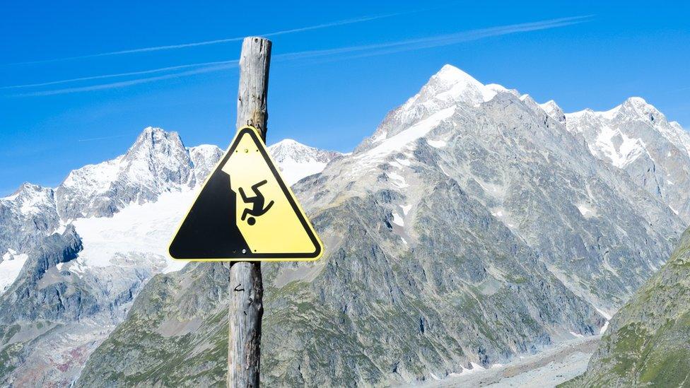 Slippage danger sign with Miage Glacier and Combal peaks in the background, August 2014